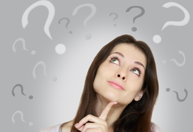 woman looking up thinking with questions marks around her head