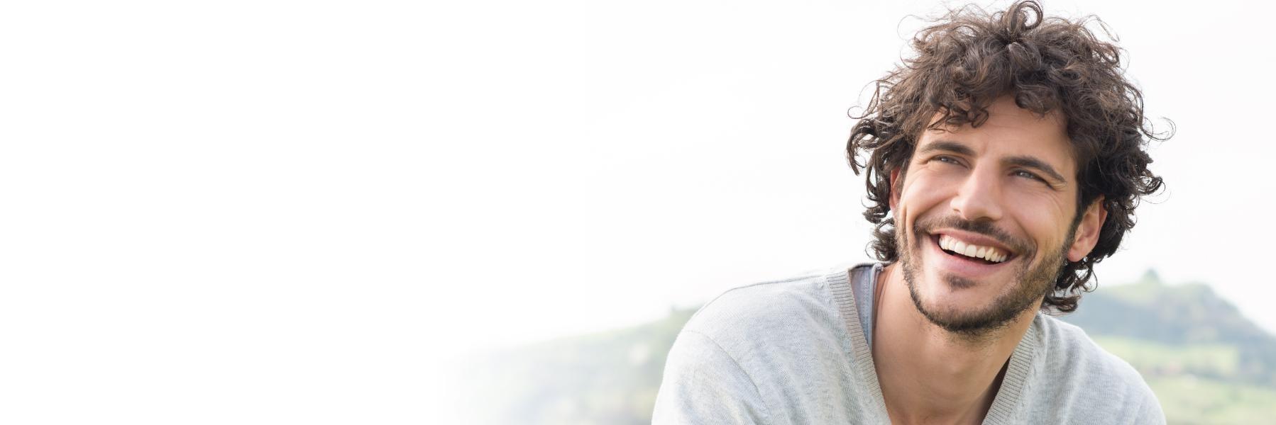 Dental patient with bruxism smiling near 95928